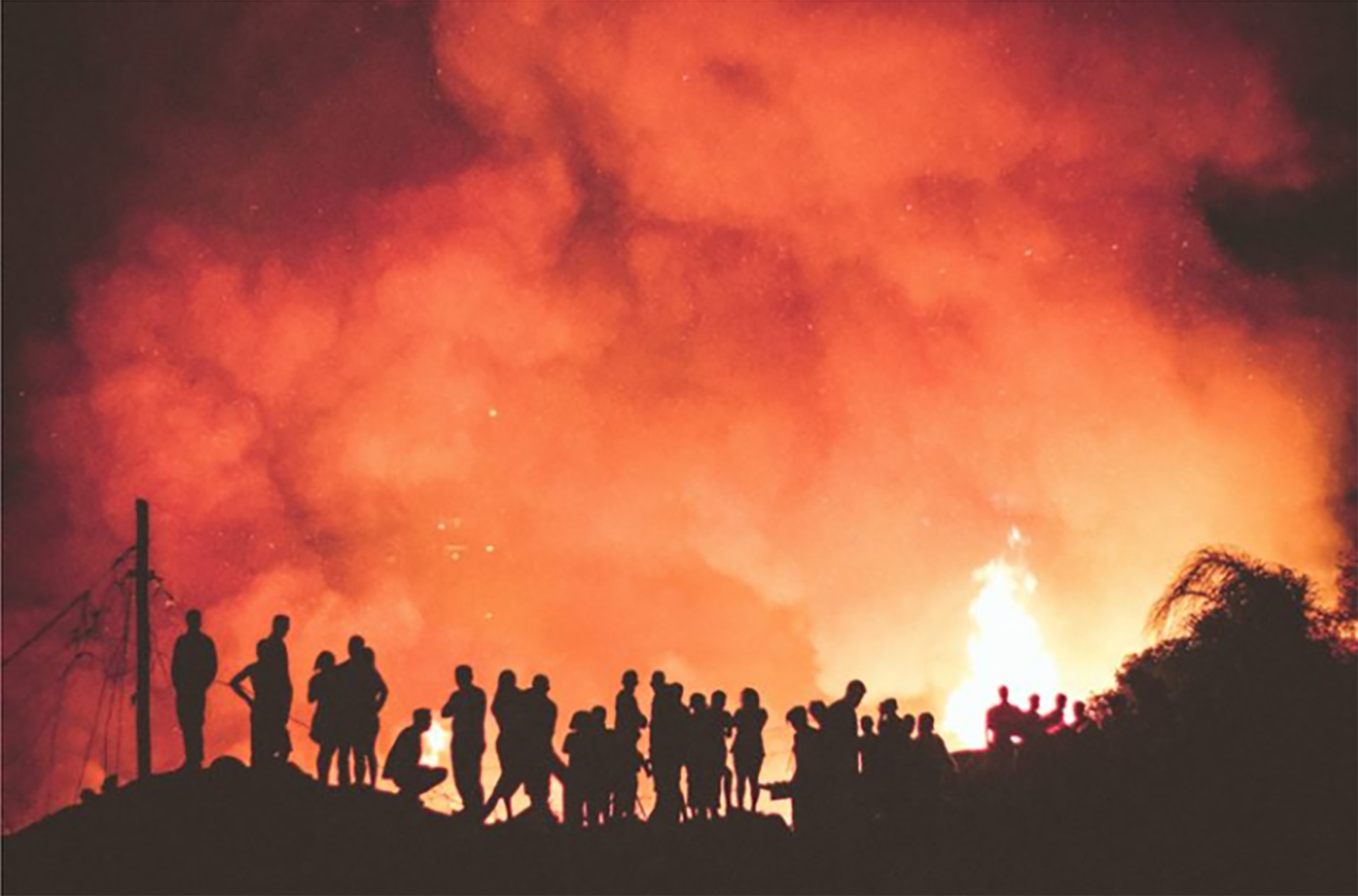 people watching a wild fire in Brazil