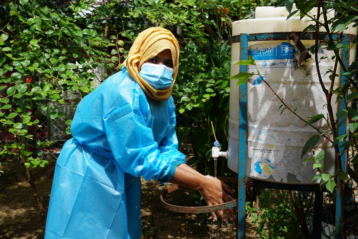 A midwife at IOM Health Post, Marina Akter using the handwashing station before attending to the labour